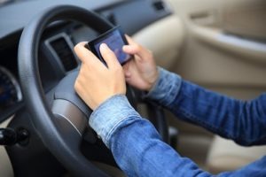 woman driver use her cell phone in car