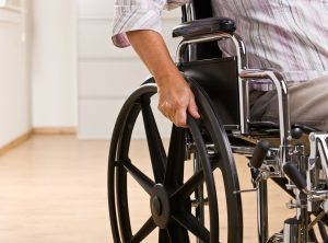 Man indoors in wheelchair