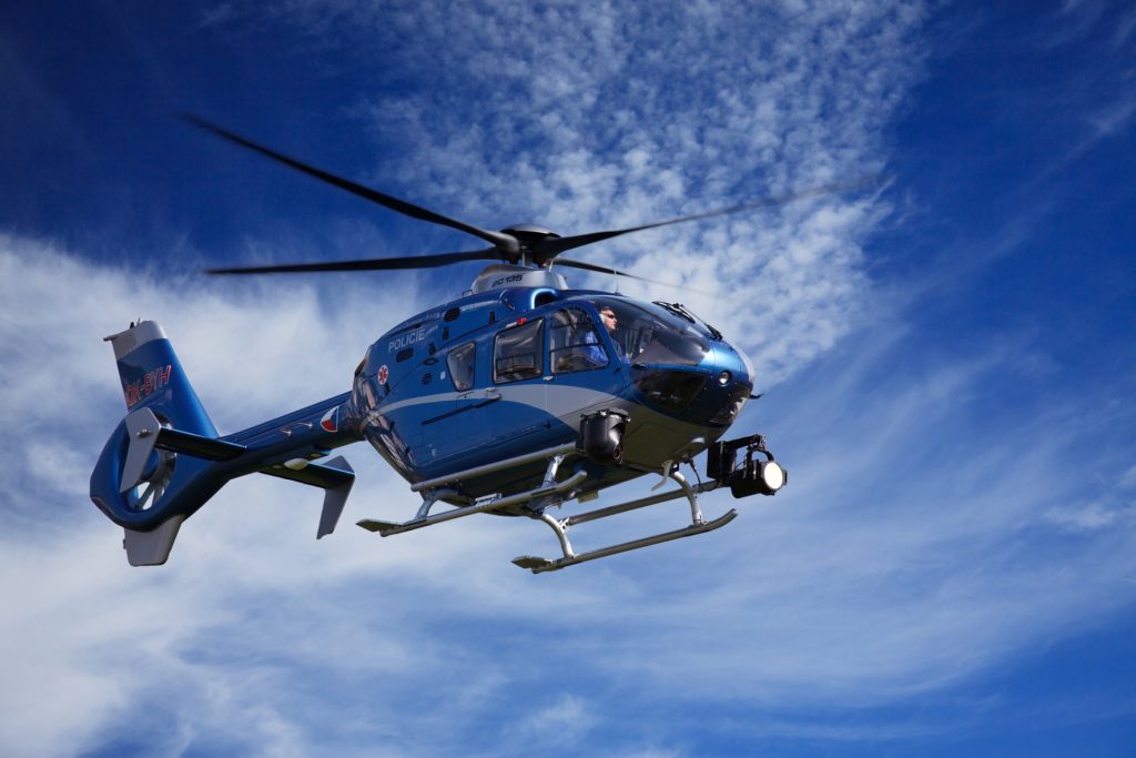 Helicopter flying against a blue sky